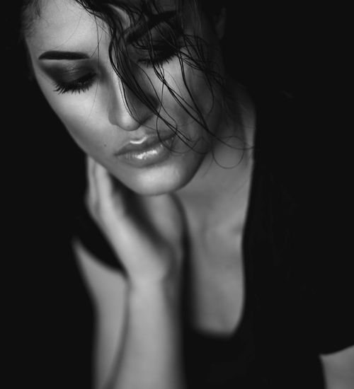 Woman with a serene expression, eyes closed, focusing inward.